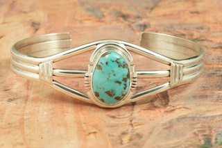 Genuine Royston Turquoise set in heavy gauge Sterling Silver Bracelet. The Royston Turquoise Mine is located in Nye County, Nevada. Created by Navajo Artist Arkie Nelson. Signed by the artist.